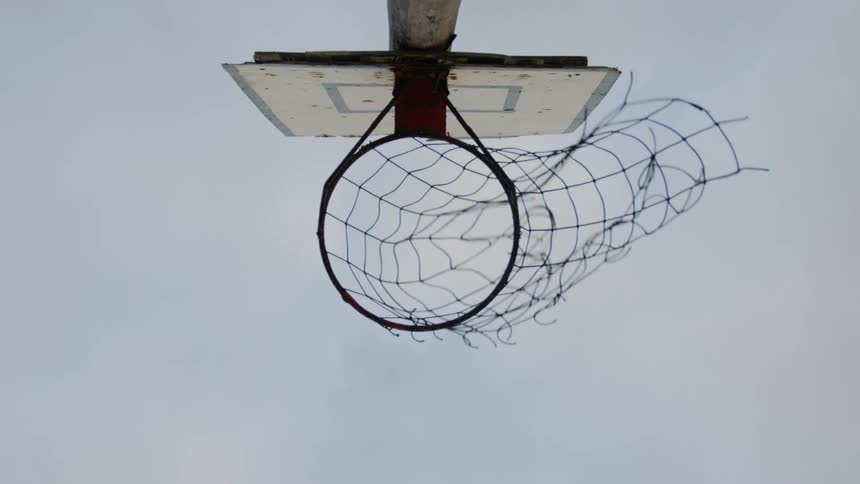 A person shoots and hits the basket