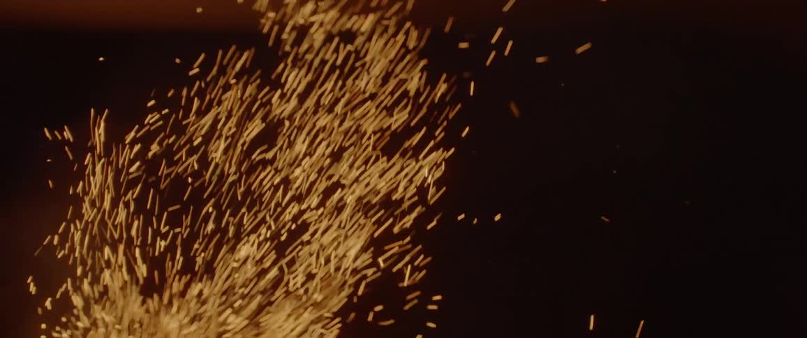 Sparks fly from a burning fire
