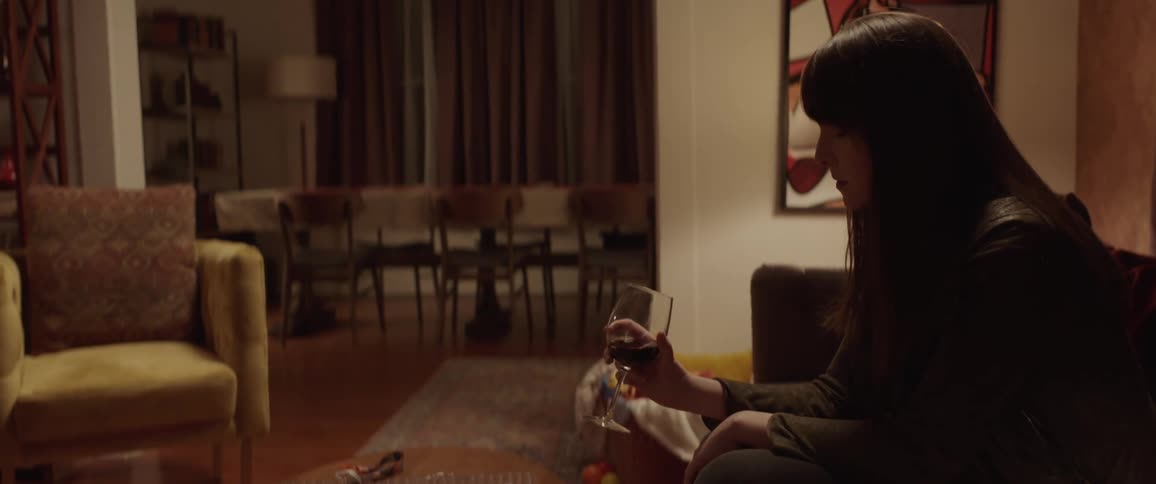 A woman holds her wine glass