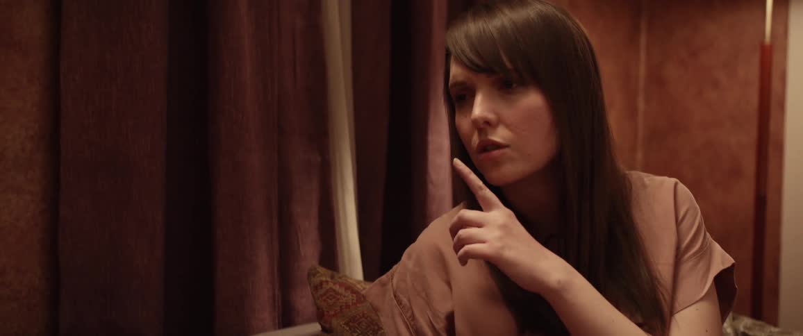Woman sitting on room ask someone else to keep quiet