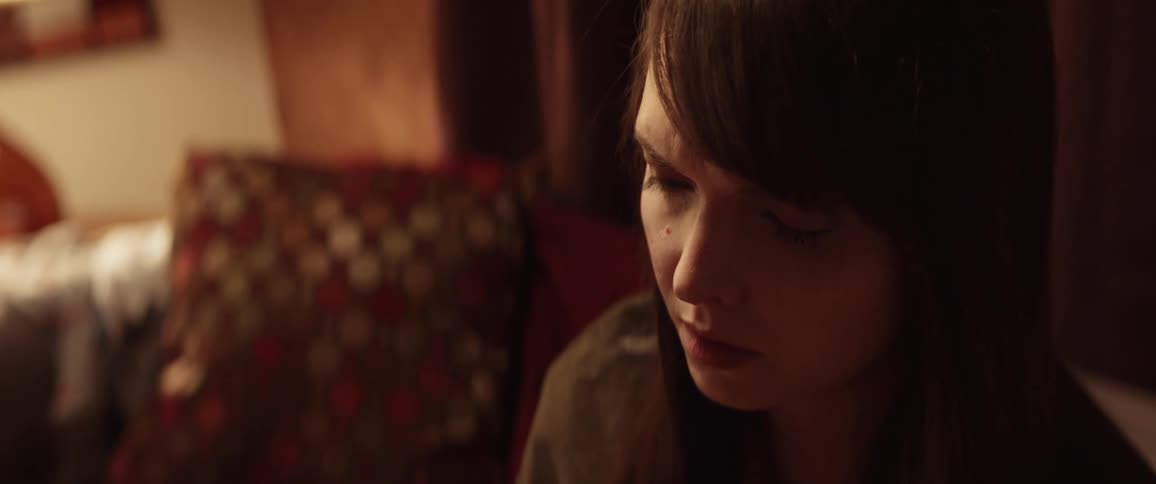 Sad woman sitting in a chair cries