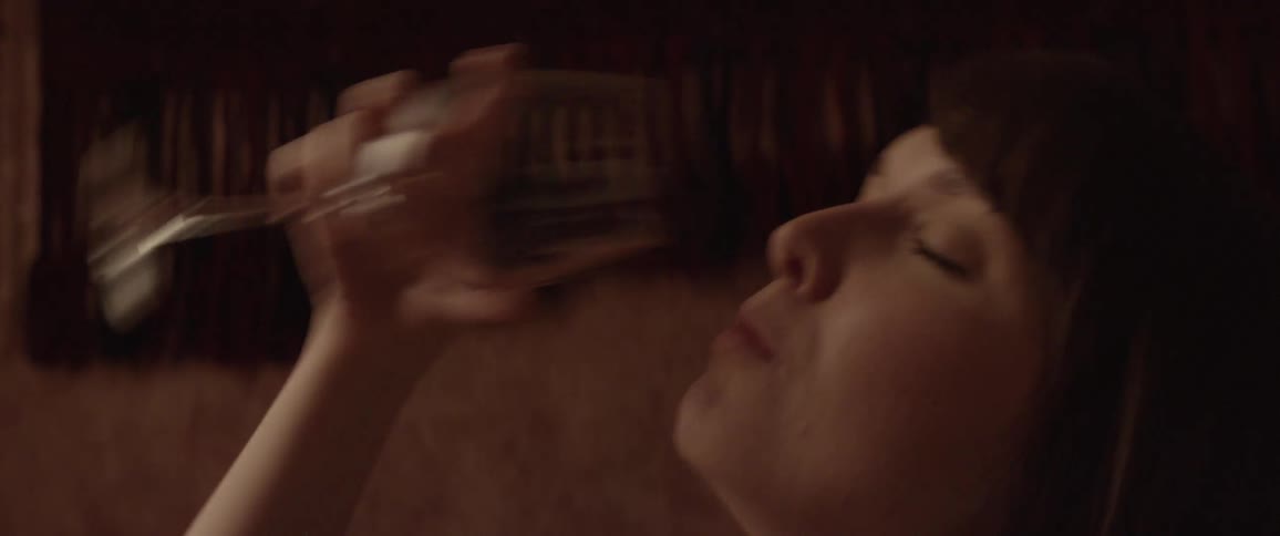 Woman drinks a glass of wine