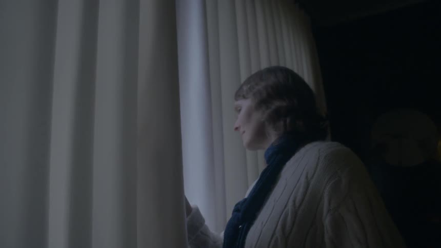 A woman looking out of a window