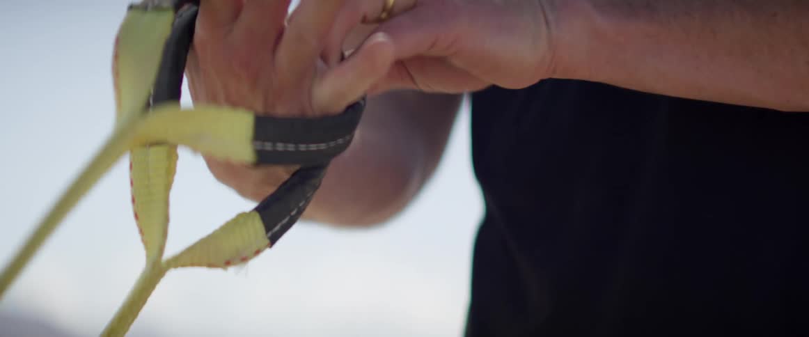 A man holds on to handles and prepares to exercise