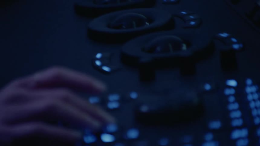 Person works on a large electronic console