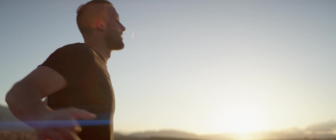 A man is working out outdoors at dusk
