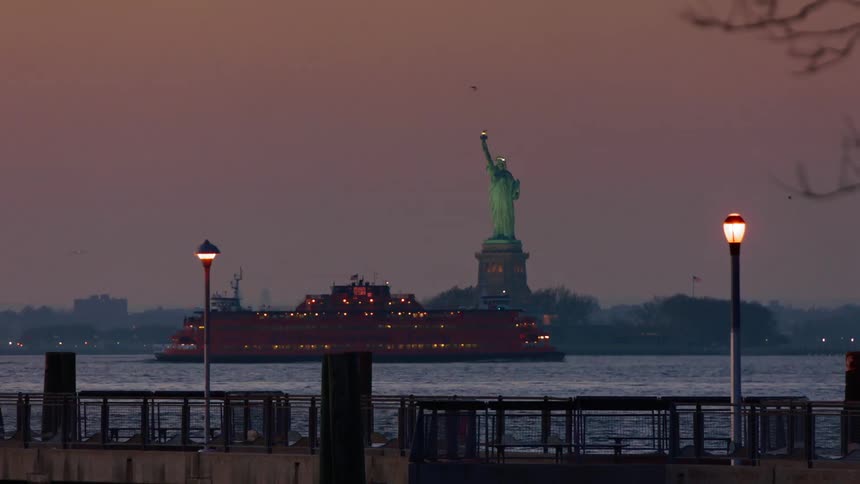 Time lapse of the statue of liberty at dusk
