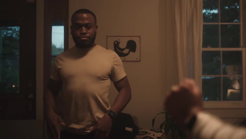 A man and woman dance inside their house
