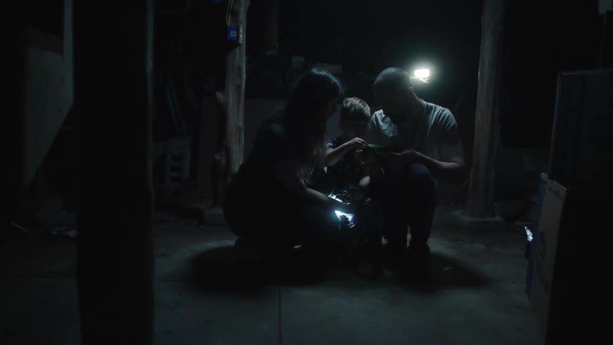 A family huddled together in the basement