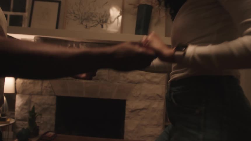 Two people are dancing in a room