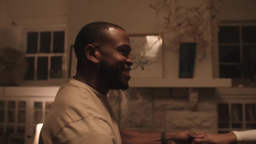 A man and woman are dancing in a room together