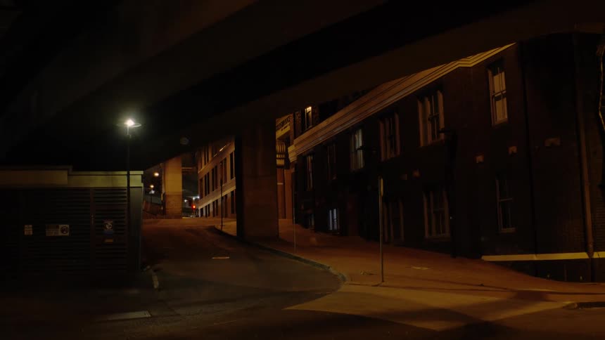 Lights of cars passing over overpass light building neighboring overpass