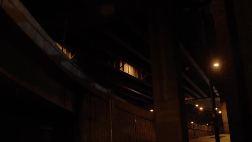 A dark tunnel outside a building at night
