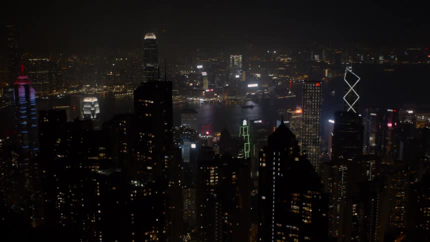 A downtown areas skyscrapers are illuminated at night
