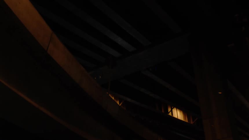 Light moves over dark wooden beams