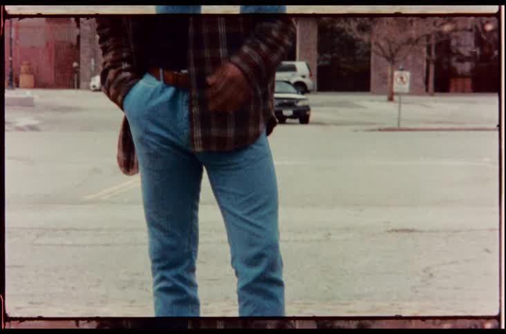 Video footage of a man standing outdoors is displayed
