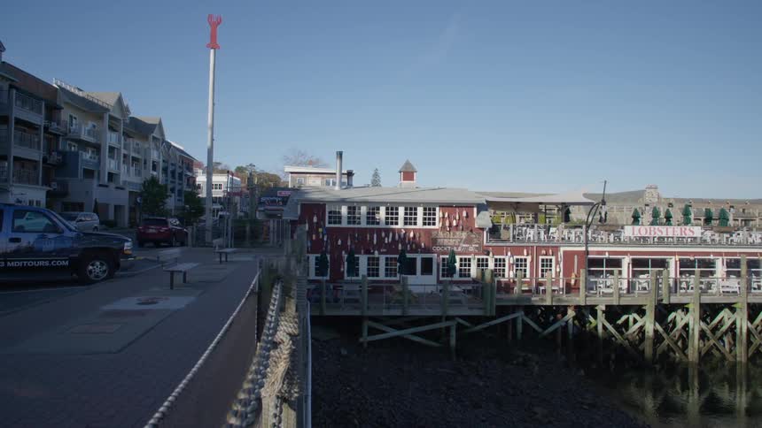 View of a restaurant on a pier next to the city