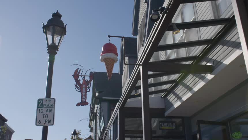 Signs hanging on the outside of stores