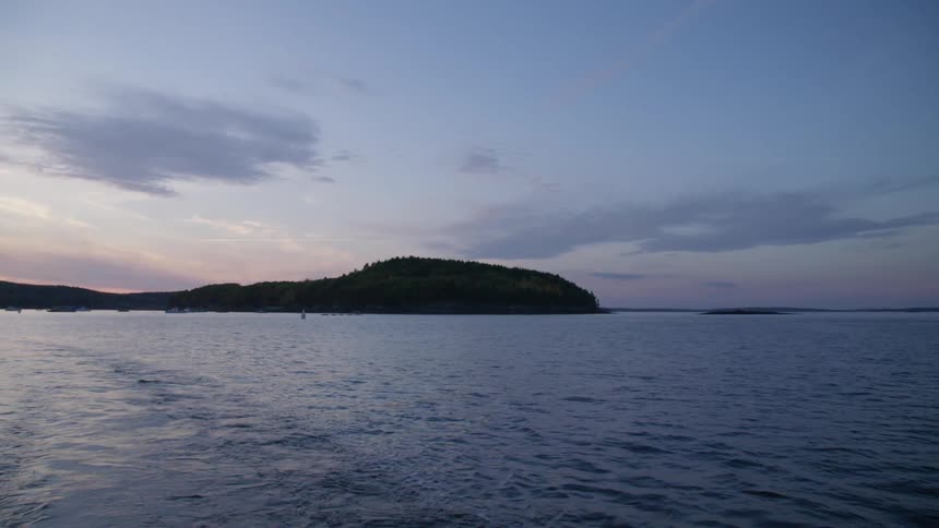 Coastal promontory at sunset near calm ocean waters