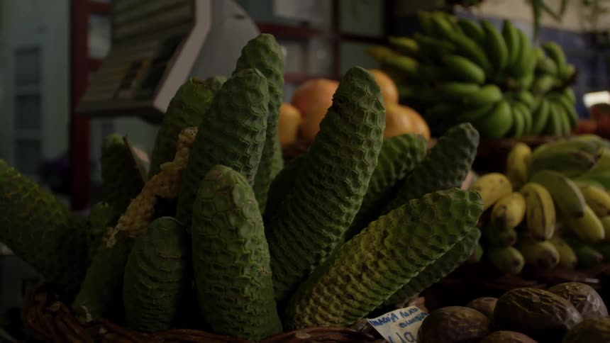 Various fruits sit in baskets at a market
