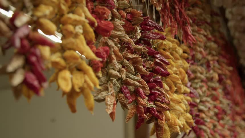 Hot peppers suspended on a rack to dry out