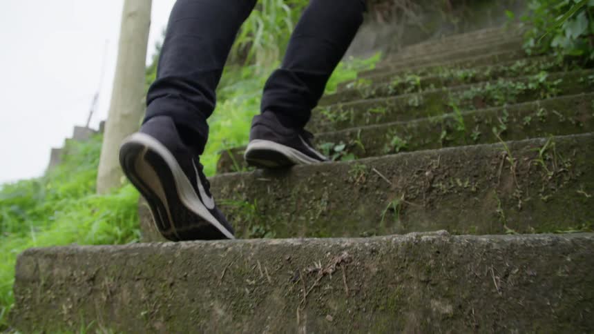 A person is walking up stairs outdoors