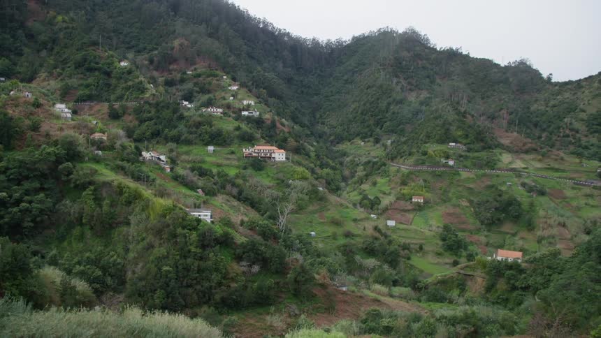 Various buildings dot the side of a mountain