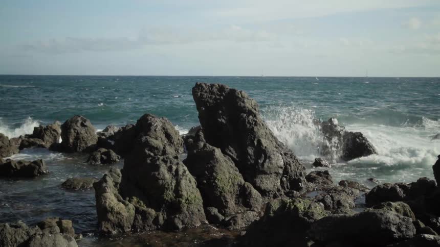 Waves crash against a rocky shoreline