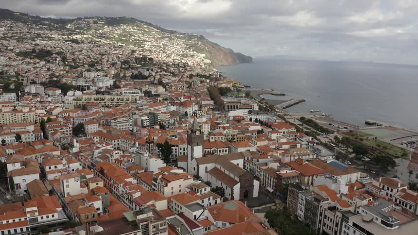Aerial view of coastal city and rooftops of houses