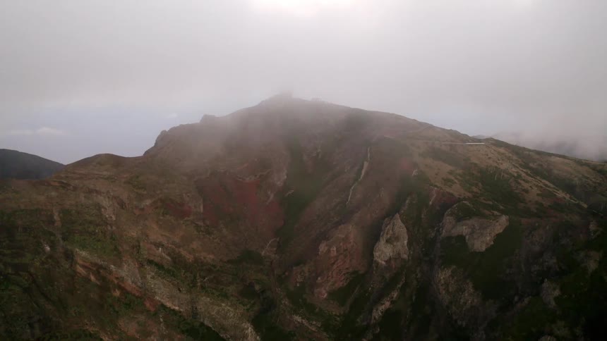 A mountain range with the sky in the background