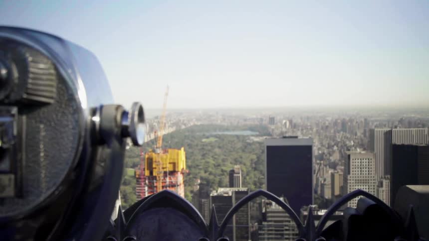 Standing near coin operated viewer person uses mobile phone to take video