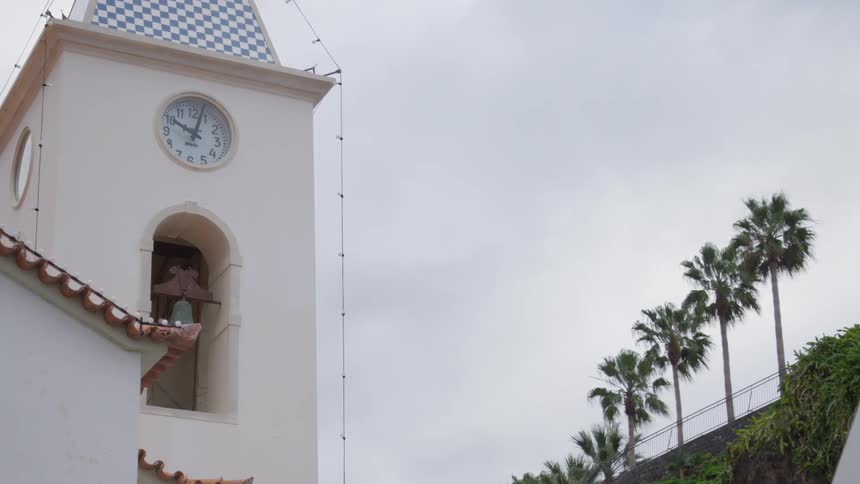 A clock tower with a bell