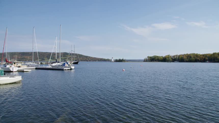 Boats on a pier in the calm waters of a lake at day