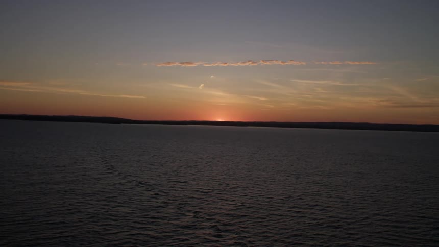 A coastline sits behind a vast expanse of ocean