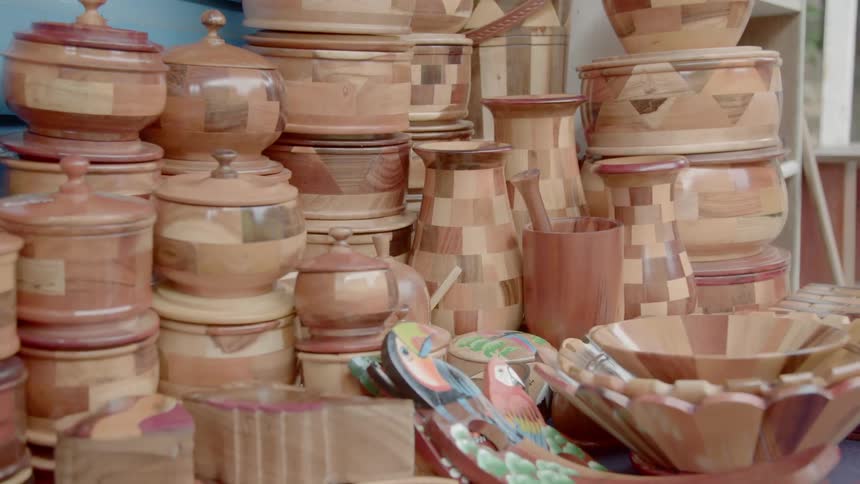 Piles of wooden containers sit in the corner of a room