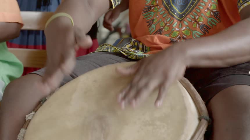 People are playing instruments in a 3rd world country