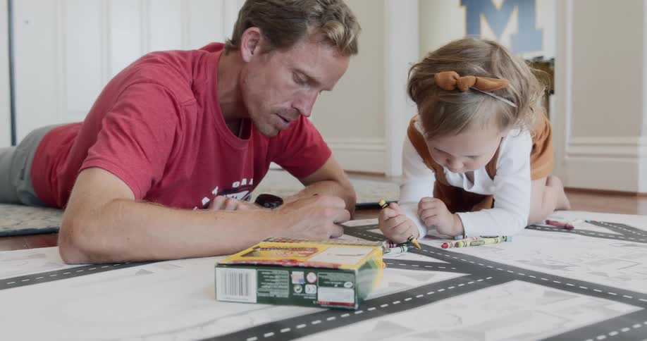 The man colors with the girl