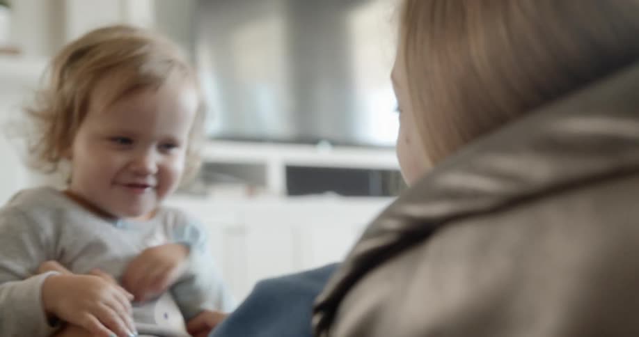 The woman tickles the child