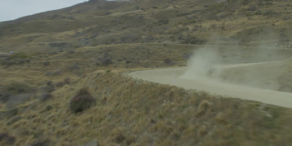 A go cart races along a dirt road out in the sticks