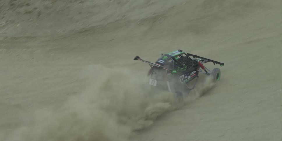The dune buggy drives on the dirt