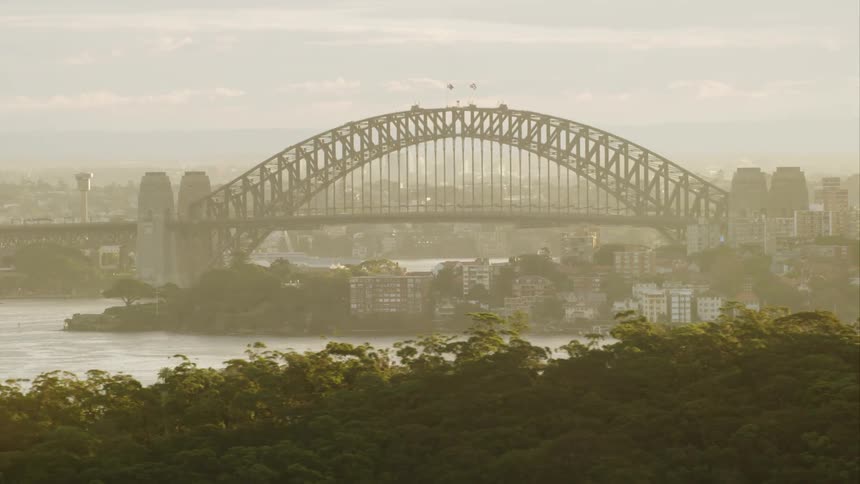 A bridge crosses a river near a city