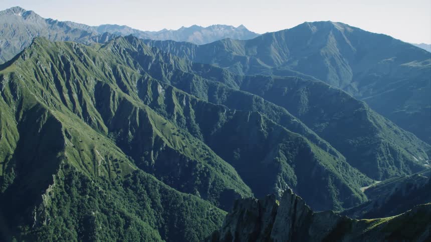 Forest covered mountain form the sides of a deep canyon