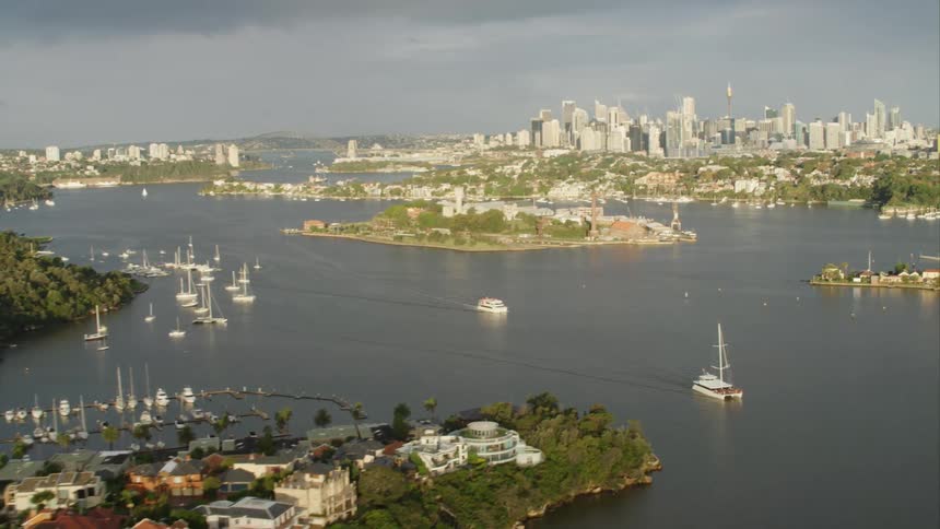 Boats in the water with a skyline in the back Sydney Harbour