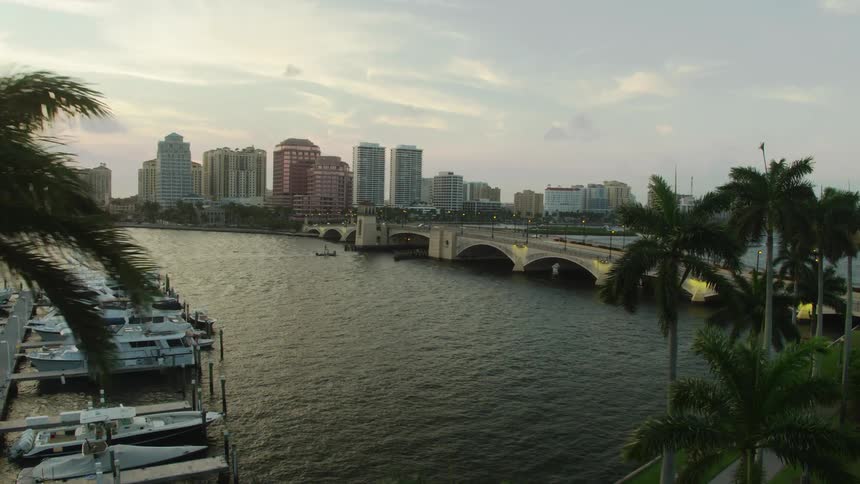 A lake with boats and a city skyline behind it