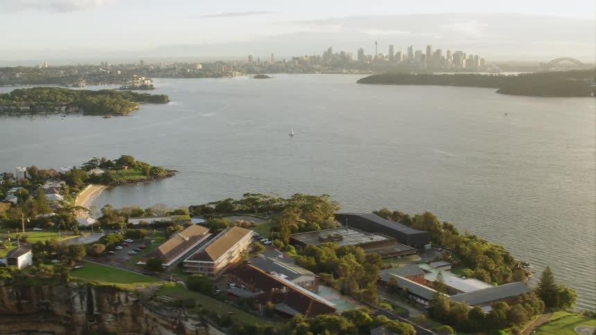 A body of water surrounded by a downtown area and neighborhoods on islands Sydney
