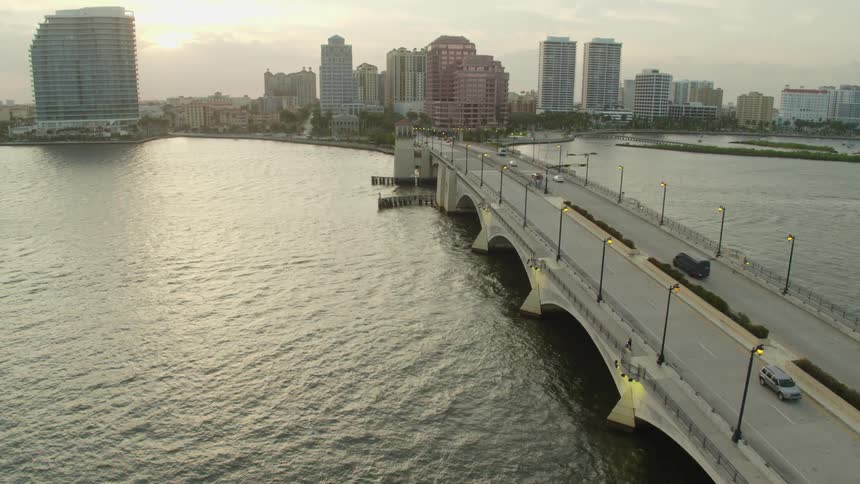 Aerial view of the city skyline and vehicles crossing the bridge in the late afternoon