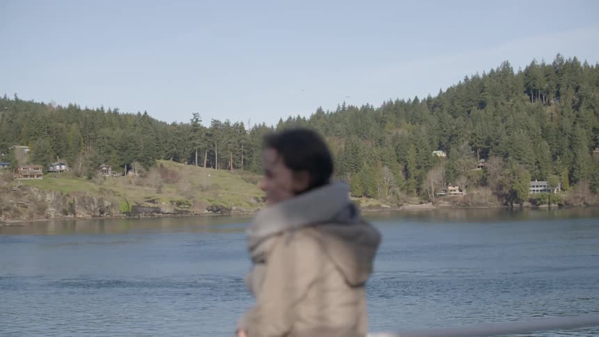Woman standing and smiling near a lake