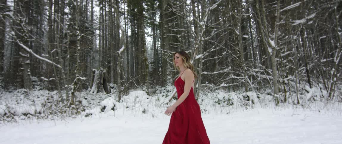 A woman walks in the snow