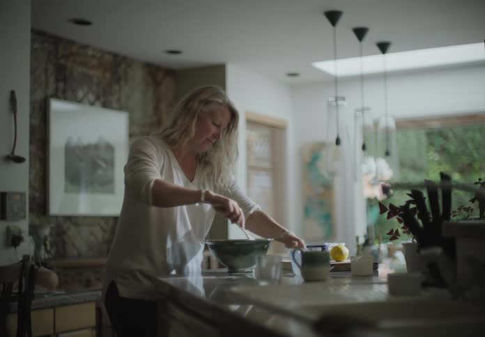 A woman cooks at home in her kitchen