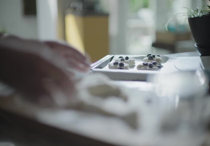 The woman bakes in the kitchen